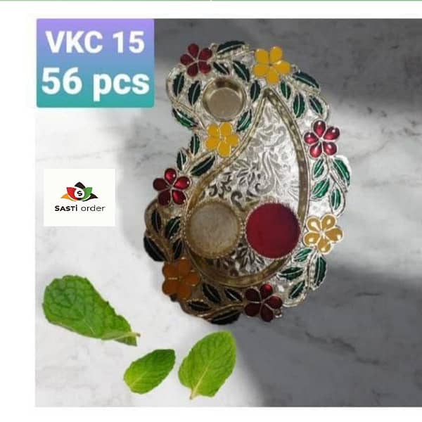 Alt Text: A beautifully designed Pooja Thali, featuring traditional motifs and multiple compartments for holding essential items like a diya, incense sticks, kumkum, and flowers. Made from high-quality materials like stainless steel or brass, it is polished for a glossy finish, symbolizing purity. Ideal for Hindu rituals and festivals, this thali is available in various sizes, with some adorned with decorative beads or stones. Lightweight and easy to handle, it offers both practicality and elegance for religious ceremonies or gifting on auspicious occasions.