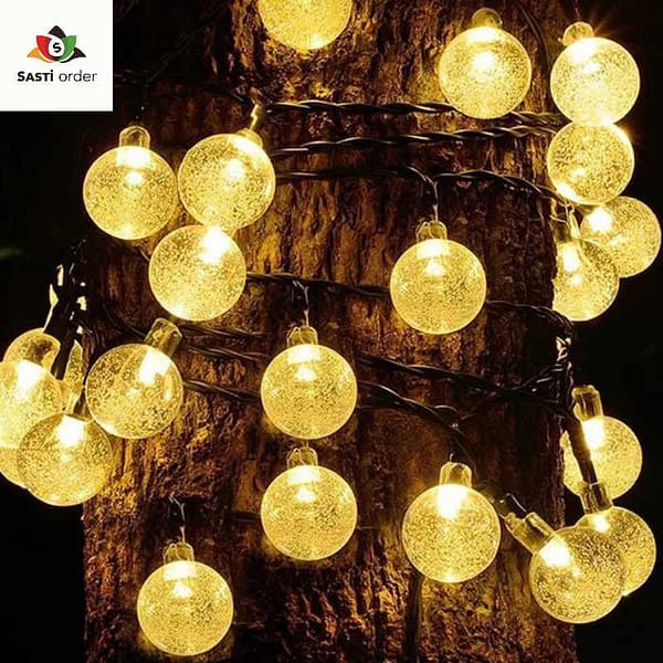 A string of 10 spherical LED lights, each glowing warmly, creating a whimsical and inviting ambiance, perfect for enhancing indoor and outdoor decor.