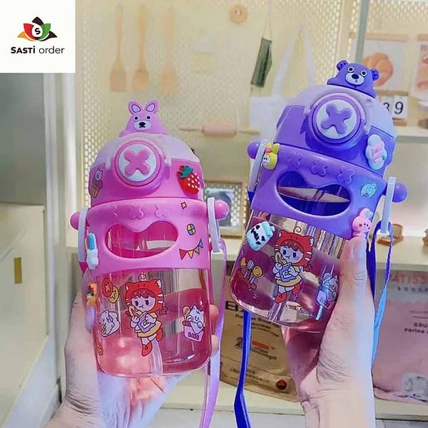 "Cute cartoon unisex kids water bottle with vibrant designs, displayed on a child's desk among school supplies."
